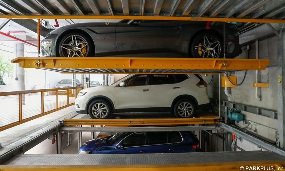 Side view of a ParkPlus Lift-Slide system showing three levels: a vehicle at pit level below grade, one at ground level and one on the raised upper platform