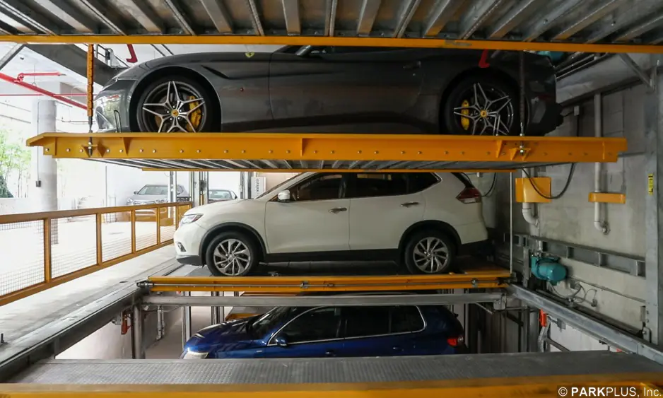 Side view of a ParkPlus Lift-Slide system showing three levels: a vehicle at pit level below grade, one at ground level and one on the raised upper platform